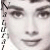 Black-and-white pixelated portrait of a woman with dark eyebrows and lips, displayed in four quadrants with partial text on the left edge.
