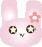 Pixelated pink bunny head with large eyes and a flower on the right ear, shown in two expressions: one with open eyes and a small mouth, another with closed eyes and a smiling mouth.