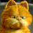 Pixelated orange tabby cat with green eyes and pink nose, cropped to show head and upper chest against blurred background.