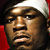 Static pixelated image of a person wearing a white headband and red clothing, cropped to show upper face and shoulders against dark background.