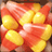 Pixelated candy corn cluster on left, red-orange and yellow segments; right side split into two solid color blocks with white text reading "Kinda CORN-y" above "Don't you think?".