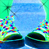 A repeated pattern of stylized sneakers with multicolored pixelated details on a blue and green background with star-like sparkles.