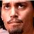 Pixelated close-up of a person's face with brown eyes, light skin, and dark hair visible on the left edge.