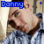 A pixelated image of a person in a blue and white checkered shirt with text above their head, showing variations in text spelling and symbols.