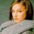 A pixelated image of a person with shoulder-length brown hair wearing a gray top, positioned next to green text reading 'Original Icons .com' on a dark background.