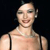 Pixelated image of a person with light skin tone wearing a sleeveless top against a dark background.