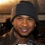 A 2x2 contact sheet of four animated frames showing a person in a dark beanie and brown jacket with slight facial expression changes, featuring blue text overlays reading "LOVE" and "USHER" on the bottom two frames.