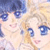 Pixelated image of two cartoon-style figures with blue eyes and light skin, one holding a small object near the other's face.