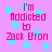 Pink background with cyan stars and repeated pink text reading "I'm Addicted to Zack Efron" in pixelated font.