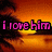 Pixelated text 'i love him' in pink with black outlines over a sunset background featuring orange and yellow gradients.