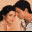 Two people in a close embrace with one person's head resting on the other's shoulder, visible in a pixelated image with warm tones.