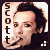 A pixelated portrait of a person with dark hair and light skin, wearing a black top, with the name 'scott' vertically aligned on the left side.