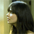 Pixelated profile view of a person with long dark hair, light skin, and a neutral expression against a gradient background.