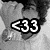 <33 icon with white text on black background over grayscale image of person's face and shoulder.