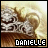 Pixelated image of a person with light brown hair and white clothing, overlaid text reading DANIELLE in blocky font.