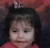 A split-screen image shows a child with dark hair and a butterfly hair clip on the left, and a pink flower with a yellow center on green foliage on the right.