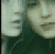 Two stylized faces in profile view with muted green and beige tones, set against a dark background with subtle pixelation.