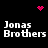 Pixelated text 'Jonas Brothers' repeated four times on black background with pink heart and dot clusters animating above, center, and right.