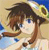 Pixelated image of a character with brown hair and blue eyes, wearing a light-colored top, set against a beach scene with sand and water.