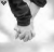 A black-and-white contact sheet of 13 animated frames showing a couple holding hands with the text "NEVER LET GO" overlaid on each frame, arranged in a 4x4 grid with one missing cell.