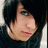 Pixelated close-up of a person with short dark hair, light skin, and a dark top, cropped to show only the head and shoulders.