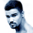 Pixelated static icon of a person's face with dark hair and facial features rendered in blue-gray tones against white background.