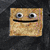 Four pixelated square icons with brown textured backgrounds show different facial expressions and poses against a dark gray backdrop.