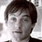 Static 48x48 pixel icon showing a close-up of a person's face with dark hair and neutral expression, rendered in grayscale tones on a light background.