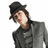Pixelated image of a person in gray suit and black hat with text overlays on black background.