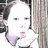 Pixelated static image of a person with short dark hair, light skin, and closed eyes wearing a white top against a blurred background.