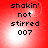 Red background with pixelated text reading 'shakin' not stirred 007' in black, featuring subtle light effects.