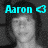 A grayscale photo of a person with cyan text overlays showing 'Aaron', a heart symbol, '7-17-07', and 'I love you.'