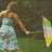A pixelated image shows a person in a light blue dress holding a colorful umbrella, with red text overlaid on black background.