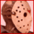 Pixelated image of a person wearing a hockey mask with multiple holes, set against red and gray background sections containing text.
