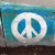 A pixelated icon features a white circular shape with blue and teal elements against a blue-green gradient background.