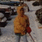 24 static images showing a child in a yellow hooded raincoat with a red hood, various poses and backgrounds including snow, indoor settings, and group photos