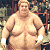 A pixelated image of a large sumo wrestler with white wristbands standing in front of an audience, next to green text reading "Original Icons .com" on a dark background.