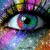 A pixelated close-up of a human eye with multicolored iris hues and visible eyelashes against a blurred background.