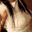 A pixelated image of a person with long brown hair wearing a light-colored top, with green text reading "CHARISMA" on a light green background.