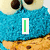 Blue cookie monster face with large eyes and a cookie mouth, displaying text changes across frames.