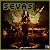 Pixelated figure with large wings and dark clothing, holding a staff-like object against a dark background.