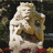 Pixelated image of a stone statue with greenery background and black text reading 'King' College' on the right.