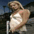 Four static views of a woman in different outfits and settings, arranged in a with no visible animation changes