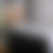 A pixelated gradient image with no discernible subjects or text, showing smooth transitions between light gray, dark gray, and muted brown tones.