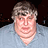 Pixelated image of a person in light blue shirt on left, bright green background with pink text reading "I think you have something on your chin! Called Flubber!" on right.