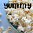 Animated sequence showing a smiling face with popcorn kernels forming the head, transitioning from 'YUMMY' text to 'POPCORN' text.