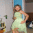 A pixelated image shows two figures: one in a light green dress with hand on hip, another holding purple and white objects against a blurred background.