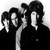 Black-and-white pixelated image of four figures in dark clothing with high-contrast lighting, appearing to be a low-resolution historical icon or logo.