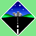 Pixelated diamond-shaped icon with blue night sky, green hills, black road, and gray cityscape; animated rock moves across the road.