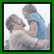 A 54x54 pixel animated buddy icon featuring a contact sheet layout with two frames: left frame shows a blurred image of two people embracing, right frame displays red text "The Notebook" on pink background.